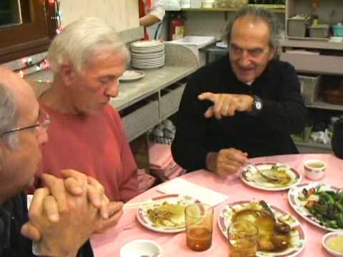Three ROMEOWS members in animated conversation over dinner